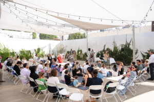 families in ECC pAVILION under a tent celebrating